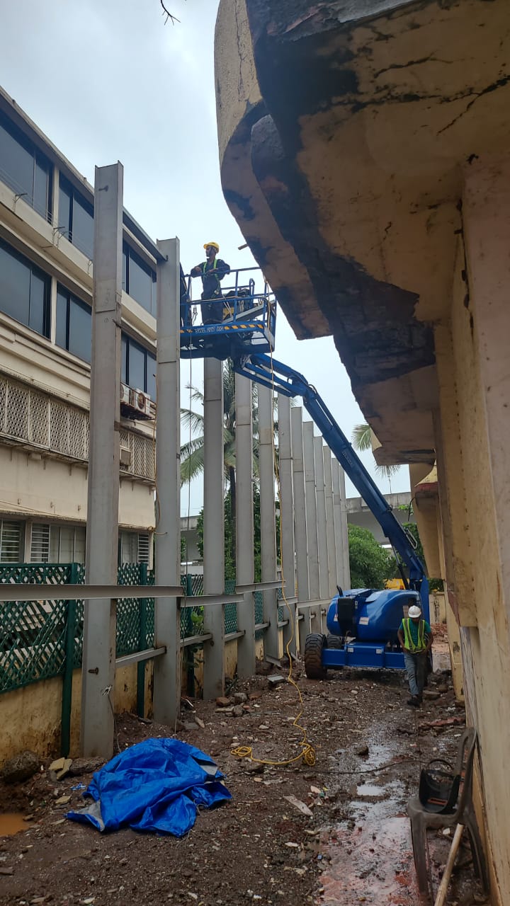 Articulating boom lift used for demolition work by Star Construction.